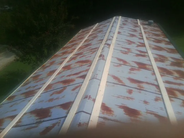 Rusted metal roof panels with new wood purlins before replacement — Storm Damage Roof Repair in Highland Falls by Roofing Brothers