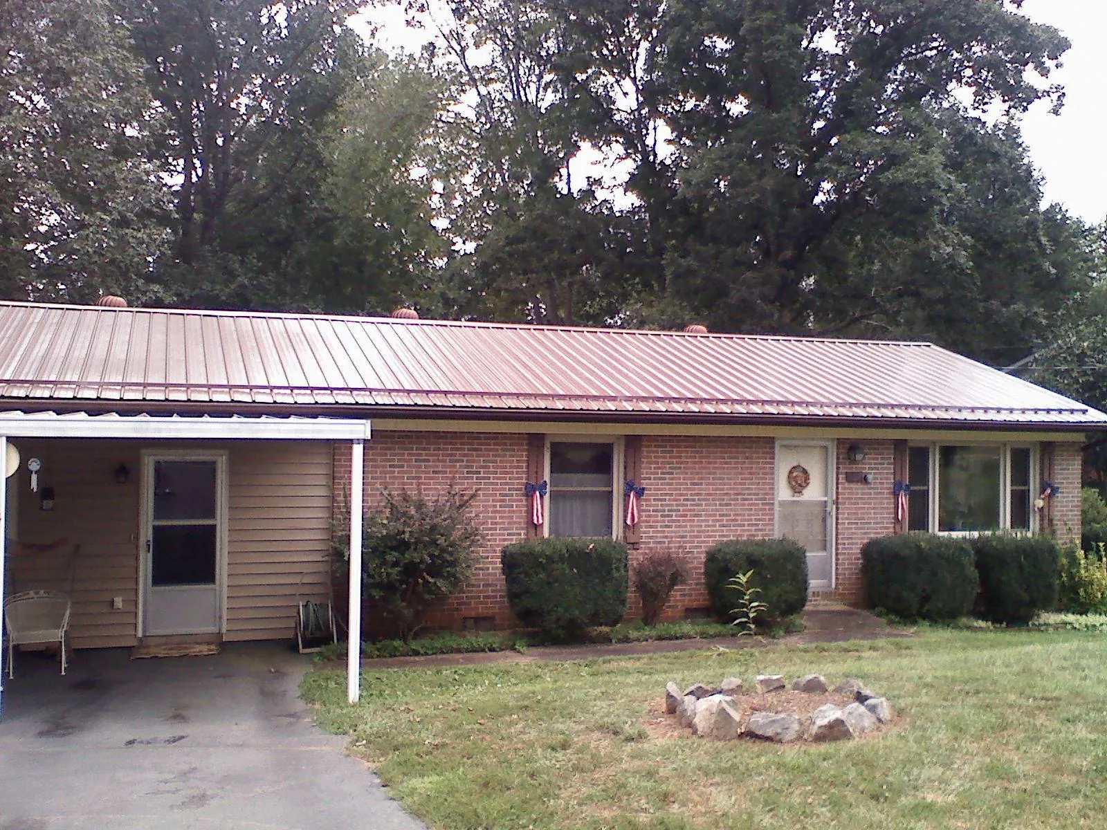 Bronze metal roof and carport on a brick ranch home — Roof Repair work by our crew in Highland Falls