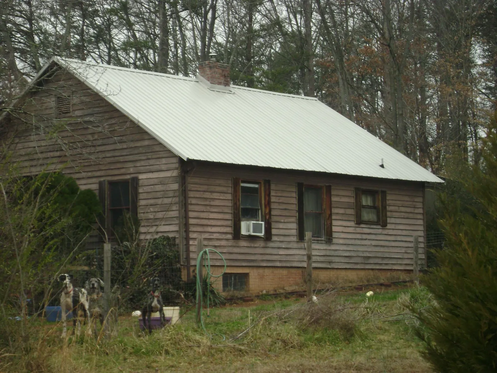 White metal roof on an old wood sided farmhouse, from a Metal Roof Installation job in Highland Falls